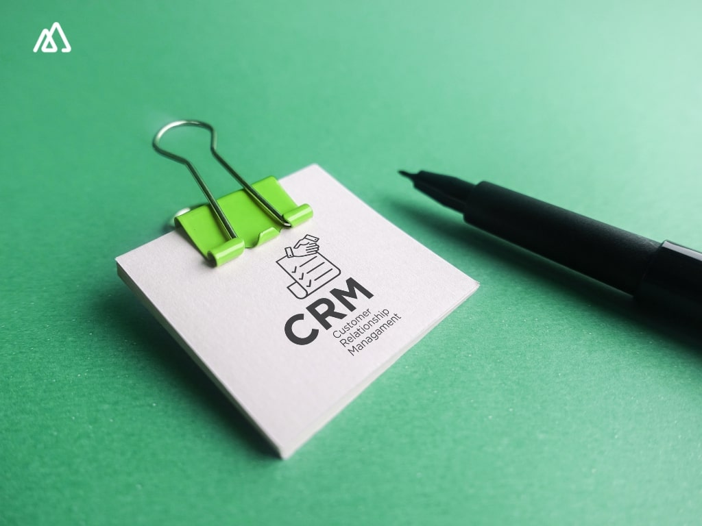 green bg and sticky note with CRM written on it
