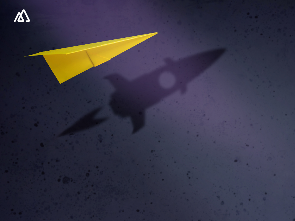 yellow paper aeroplane and a rocke shadow